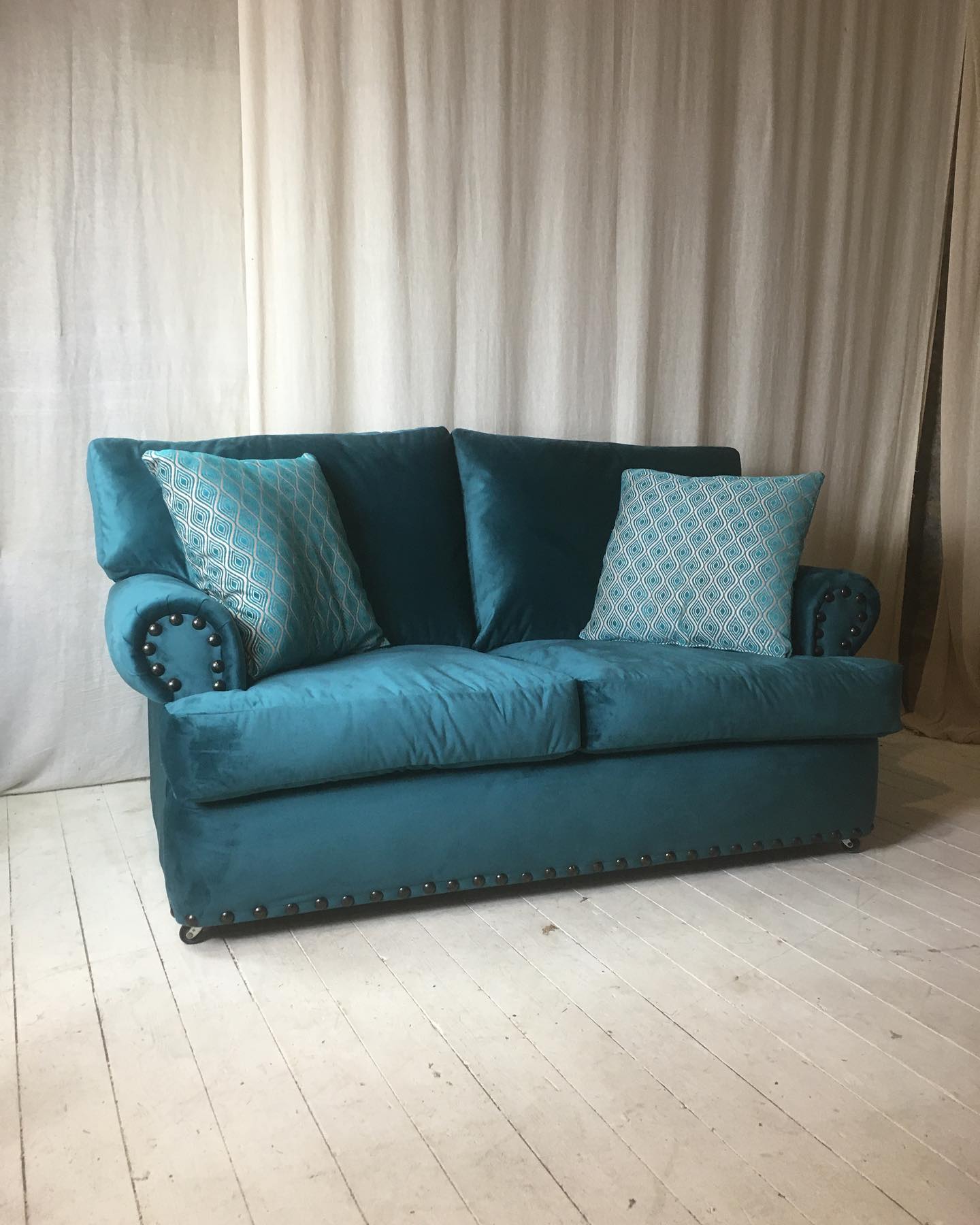 Its nice to refurbish and reuse things as opposed to sending them for landfill. So we reupholstered this two seater. Now its like new. Large plump fibre cushions make it wonderfully comfortable. In teal velvet and ready for a new home. £549